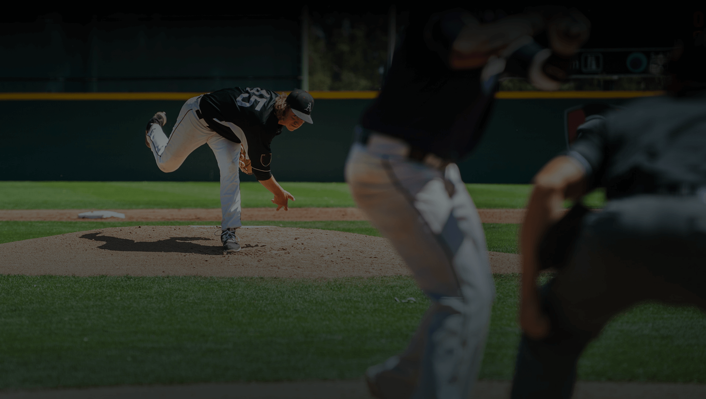 Baseball pitcher throwing from the mound to the waiting batter and umpire